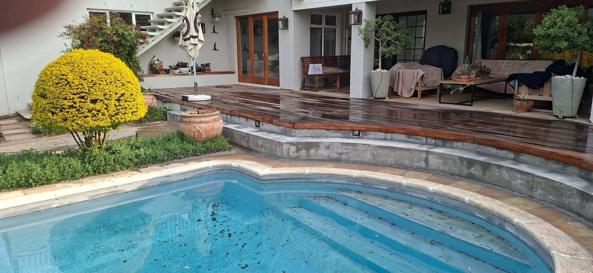 Balau deck restoration in progress beside a swimming pool