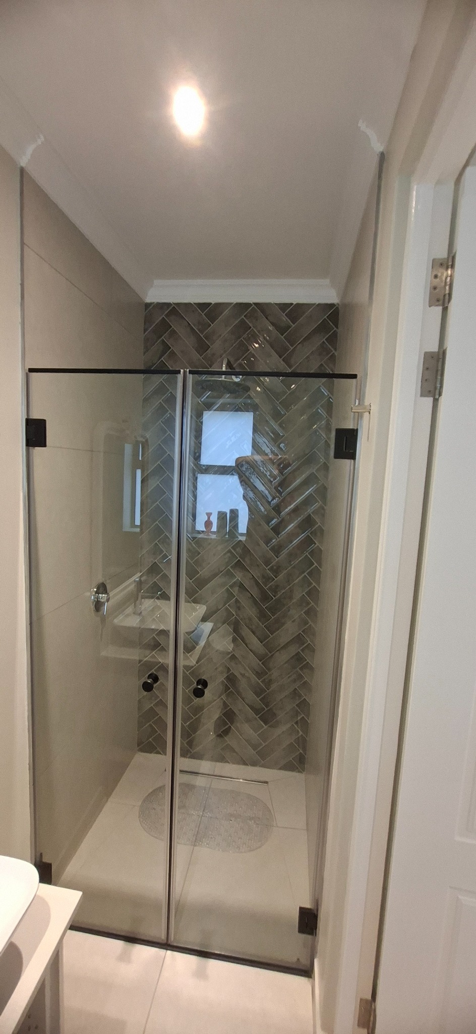 Completed tiled shower and glass enclosure